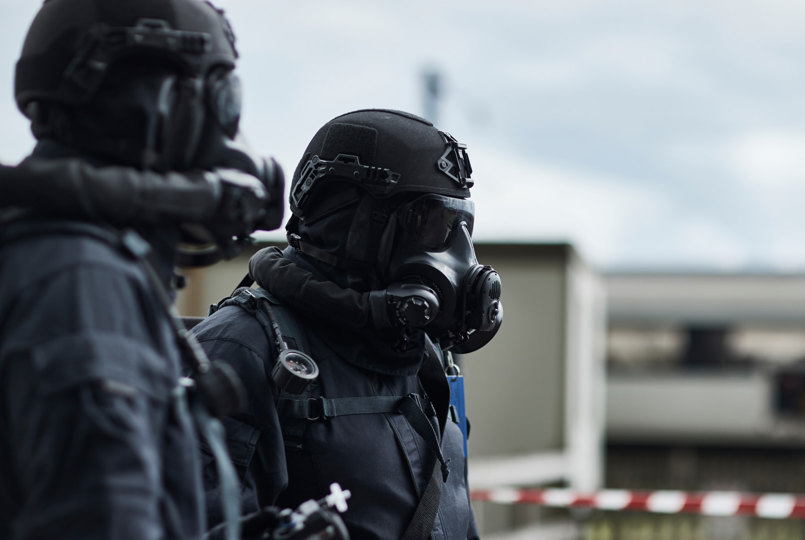 Two CBRN officers wearing a helmet and respiratory protection system