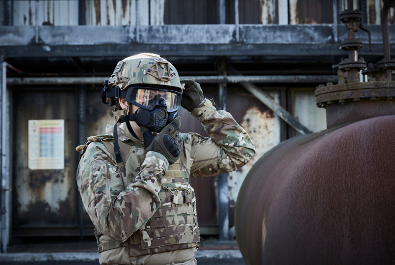 Soldier wearing a helmet and donning a respirator